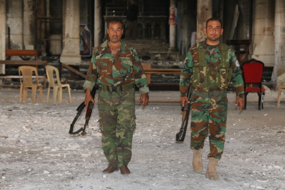  Saleh (left) claims to have killed 11 or 12 jihadists when he liberated the town