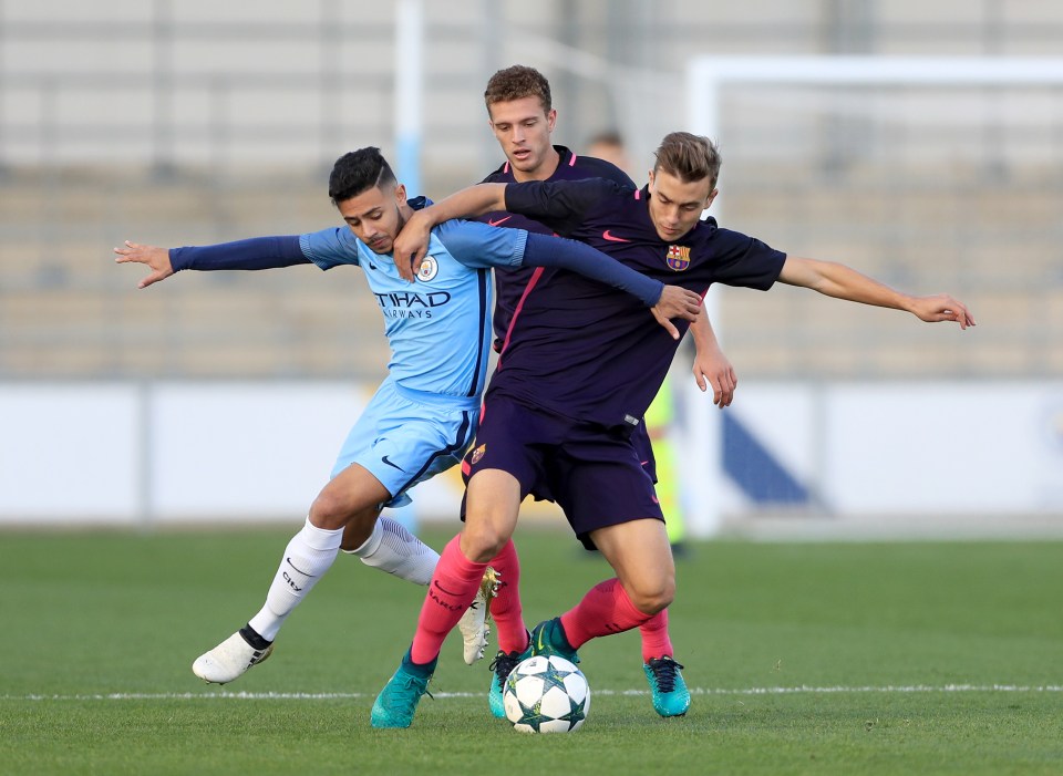 Manchester City's Paolo Fernandes and Barcelona's Jordi Tur (right) battle for the ball