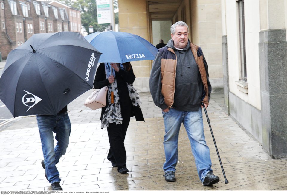 Jasmine Gregory hides under an umbrella outside court where she is accused of manslaughter and a lesser alternative of child neglect