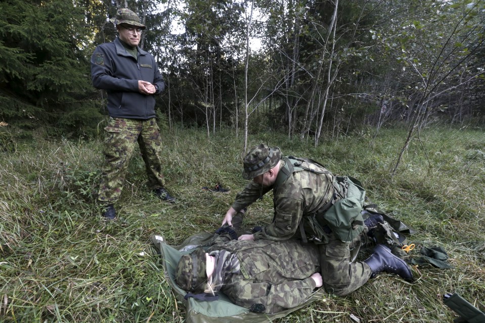 Estonia's Defence League volunteer soldier performs first aid exercise during the training drill