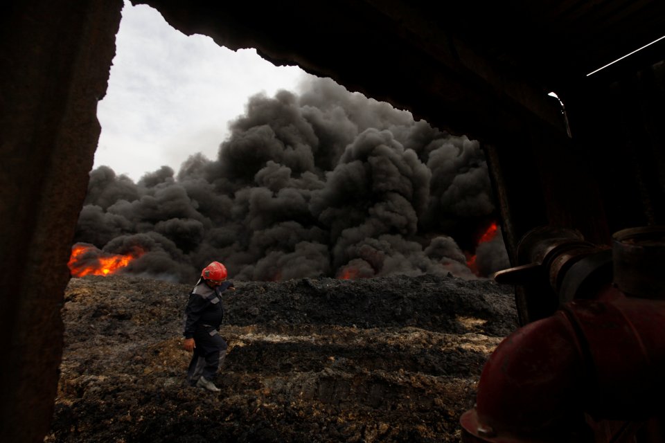  Smoke rises from oil wells set ablaze by ISIS militants before fleeing