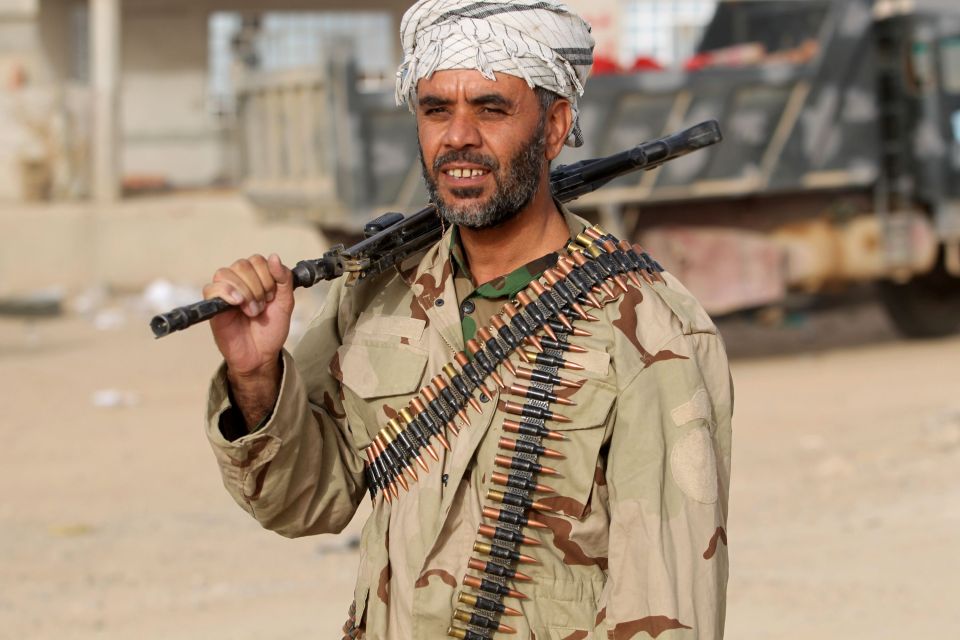  A member of the Iraqi forces walks in the village of Abu Shuwayhah, south of Mosul