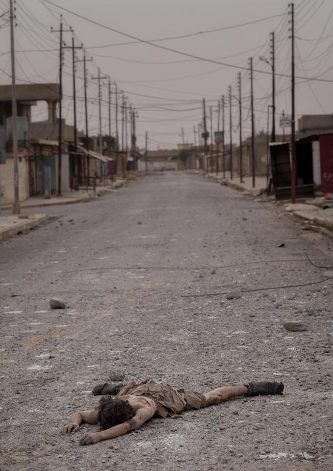 A dead body of a young ISIS fighter boy lies in the vacant street of Shora. Iraqi army troops took control of the village several days ago in the south of Mosul as part of their operations to retake the city