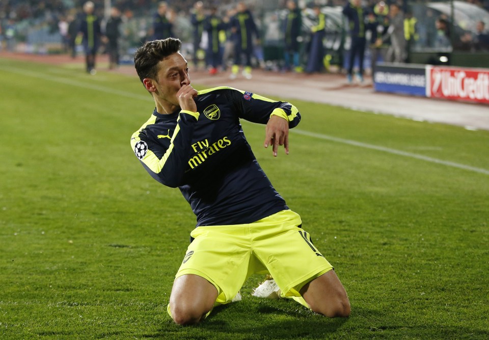 Mesut Ozil celebrates after his superb solo run and finish