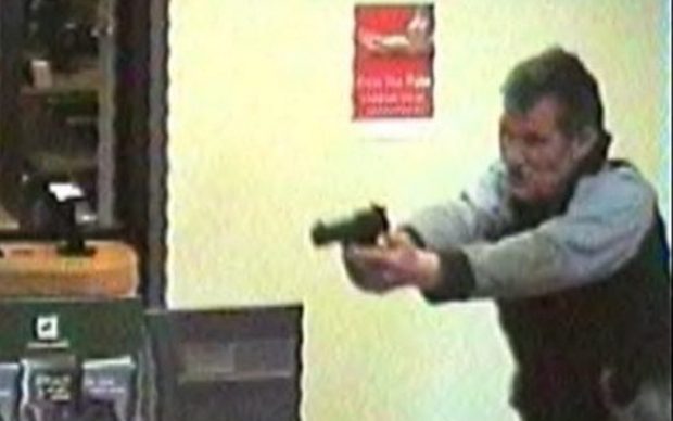 Jonathan Pay points the air-gun in the bank before shooting a customer in the head