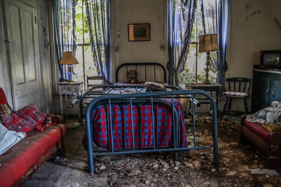 Dust and rubble line the floor of one of the bedrooms