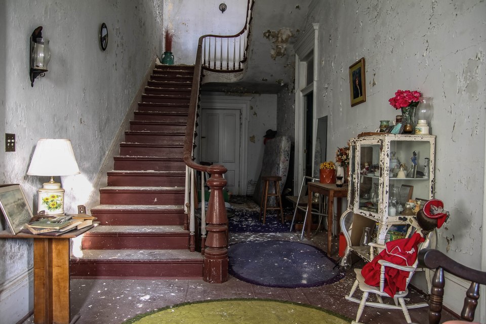 Rubble and dust cover the creepy stairway