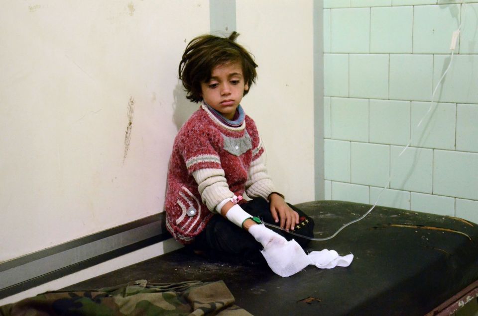 An injured child waits after receiving t