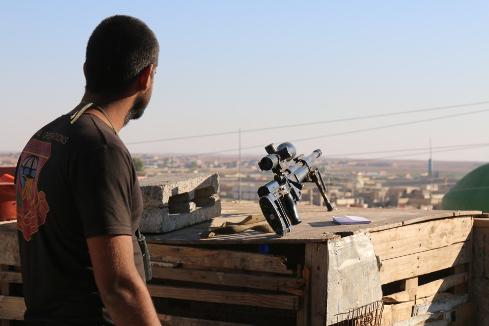  An Iraqi special forces sniper looks out across ISIS-controlled territory