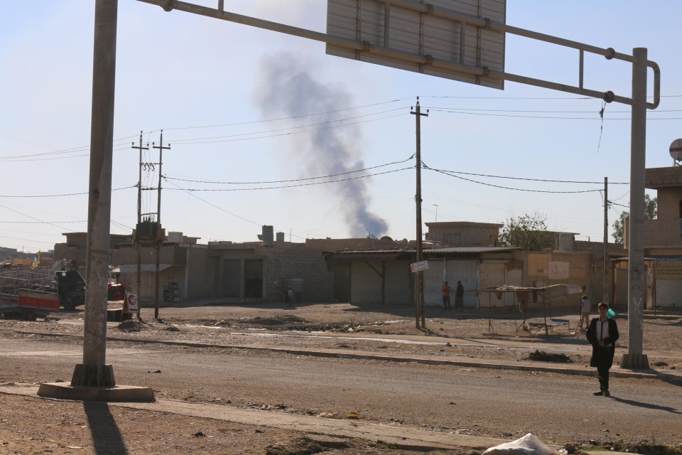  Smoke rises in the distance as clashes with ISIS troops continue nearby