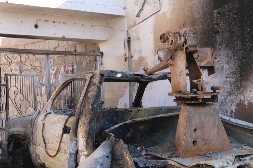  The burned out shell of an ISIS vehicle is seen smouldering in the city