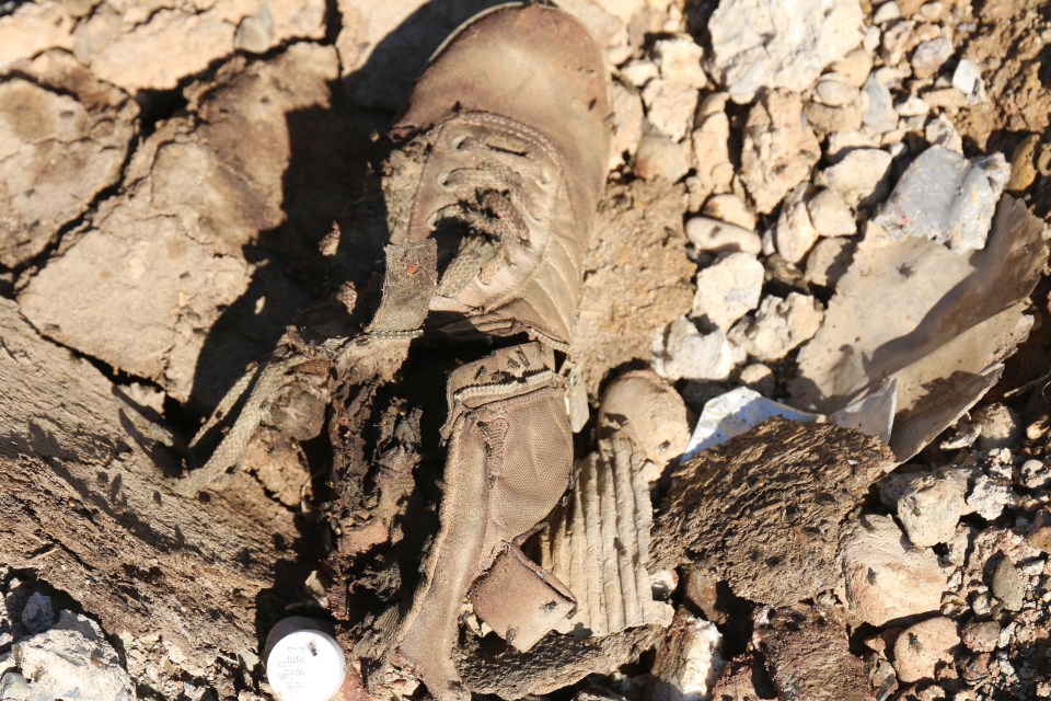  The fly-covered severed foot of an ISIS fighter was spotted amongst the destruction