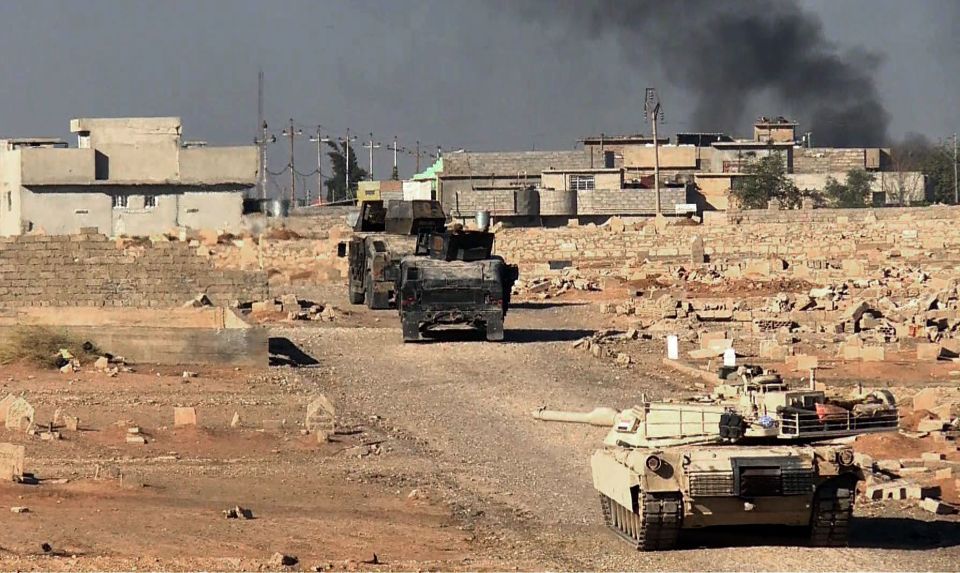  Iraqi forces in an M1 Abrams tank hold a position during their advance into eastern Mosul