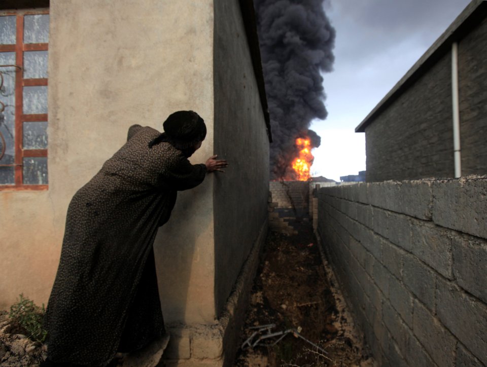  A local stares at the massive oil well fires engulfing the regions surrounding Mosul