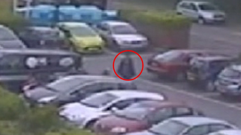 The man is seen walking purposefully into the supermarket car park