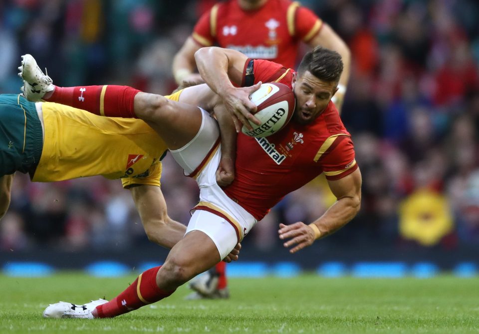 Rhys Webb of Wales is tackled during the international match