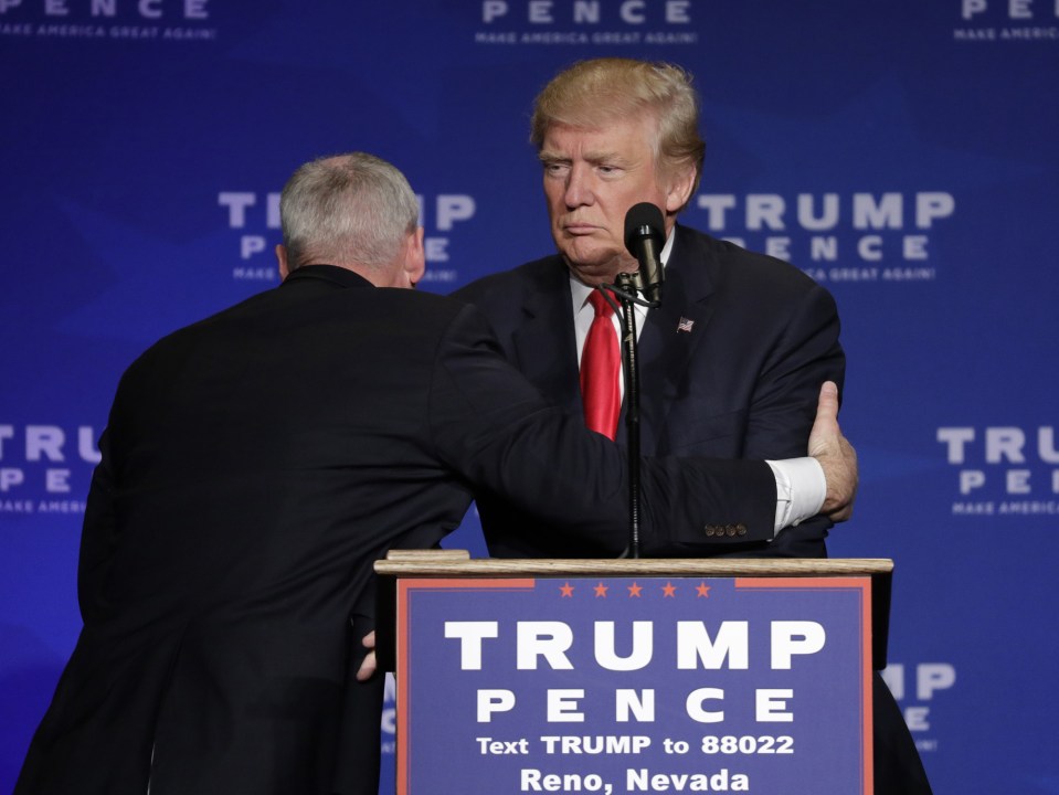  A Secret Service agent dives to cover Donald Trump during a rally in Reno