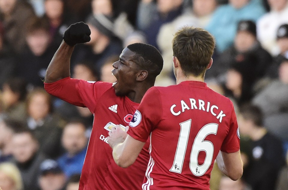 Paul Pogba celebrates with Michael Carrick after scoring his side's second goal