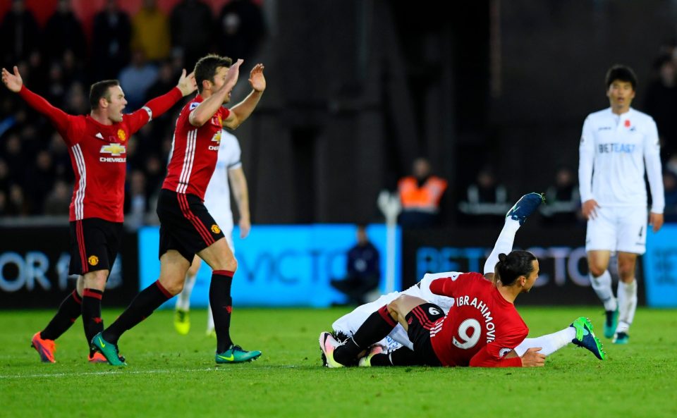  Zlatan Ibrahimovic leaves Swansea's Leroy Fer on the ground following tussle