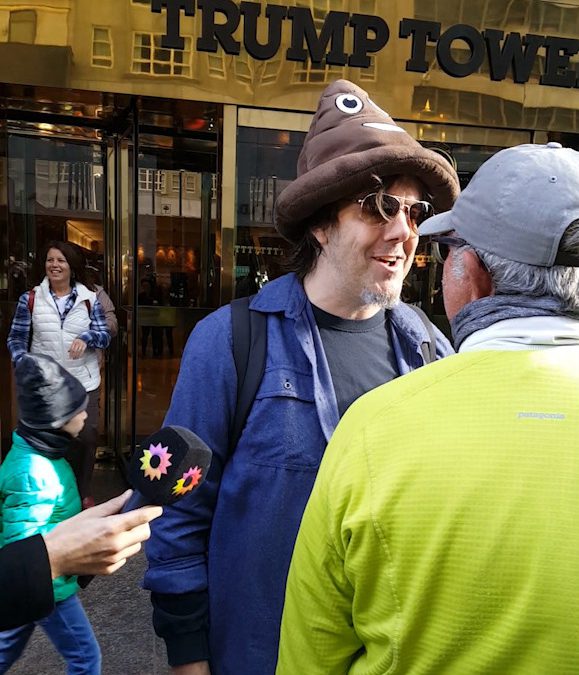 A man in a poo hat and a Trump supporter go at it at Trump Tower