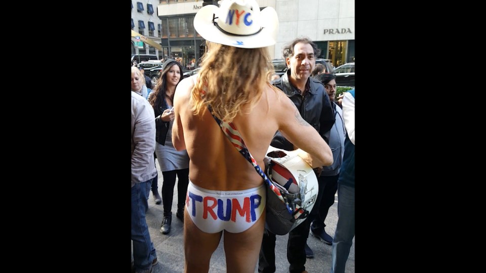 See, he's not QUITE naked... The Naked Cowboy makes his allegiances clear