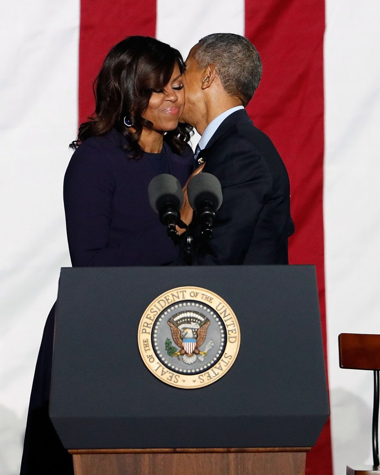  Michelle Obama embraces Barack Obama during "The Night Before" rally at Independence Hall on November 7