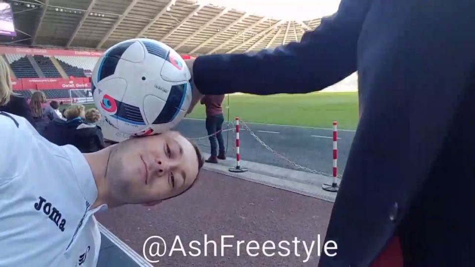  The Manchester United manager cannot resist the urge to bat the ball off Ash Randall's head