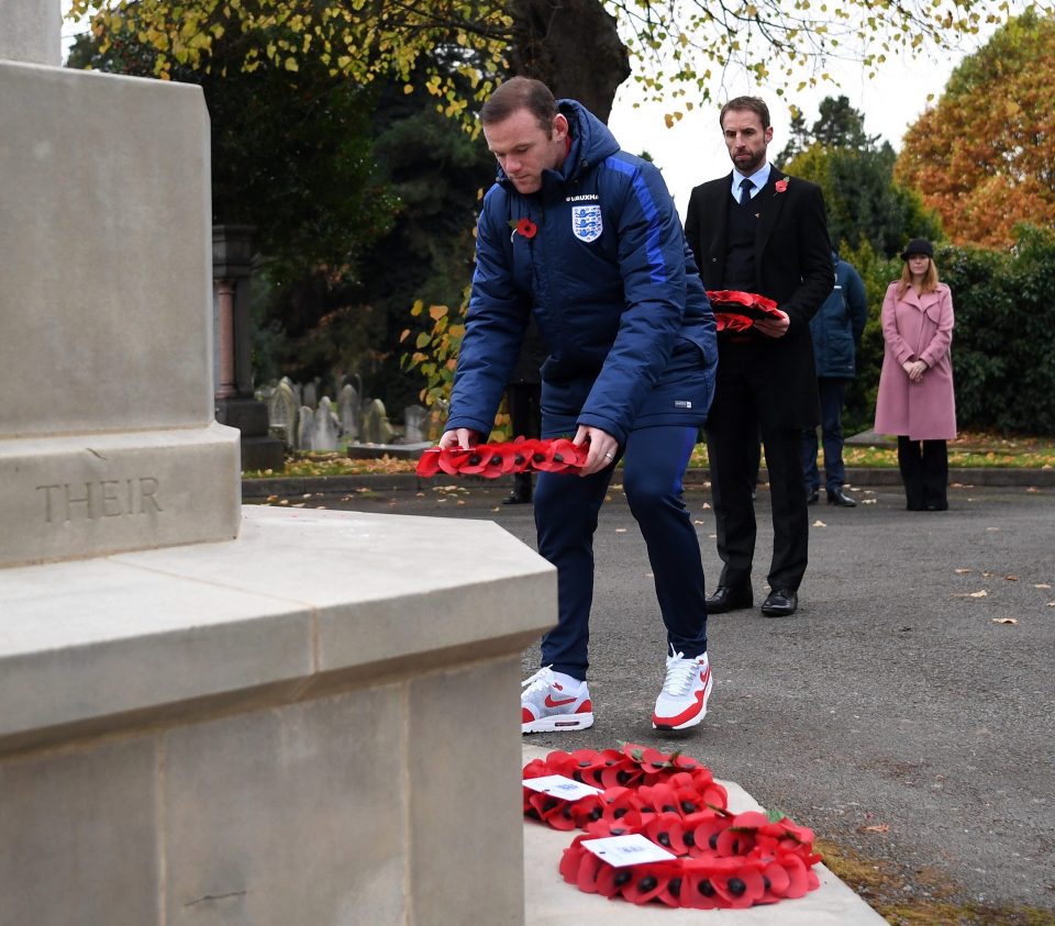 Captain Wayne Rooney lays a wreath as interim manager Gareth Southgate looks on