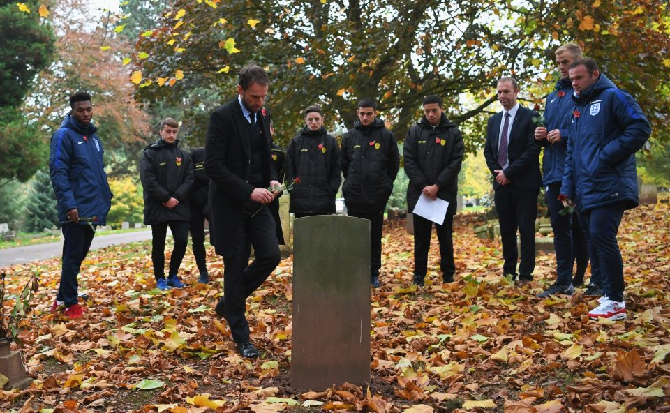 England manager Gareth Southgate places a flower on a war grave