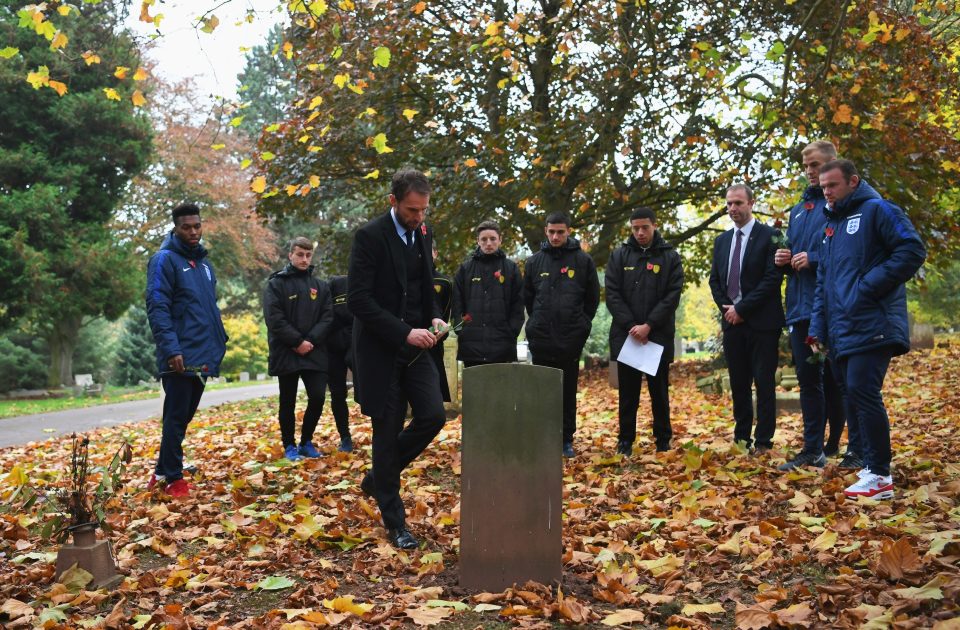 Southgate places a flower on one of the graves