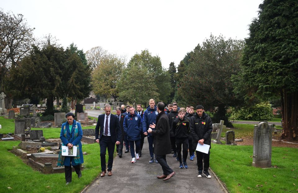 The players make their way through the cemetery