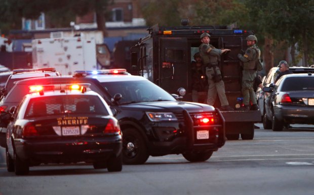 Cops attend the seen of the shooting that saw one person killed in Azusa, California