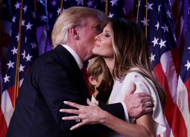 Trump is seen embracing his wife Melania Trump, who is now US First Lady