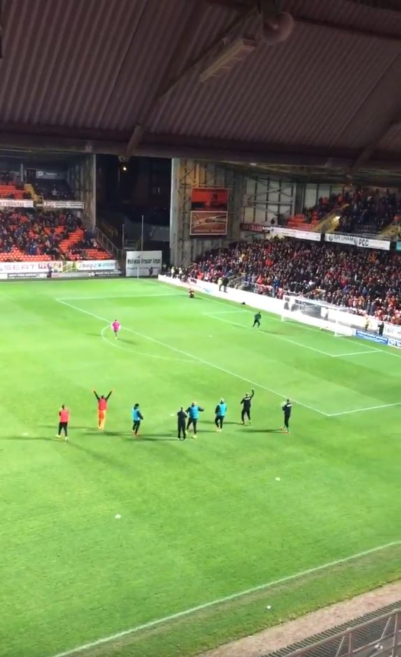  The crowd then erupts as the supporter chips the ball over the goalkeeper and into the goal