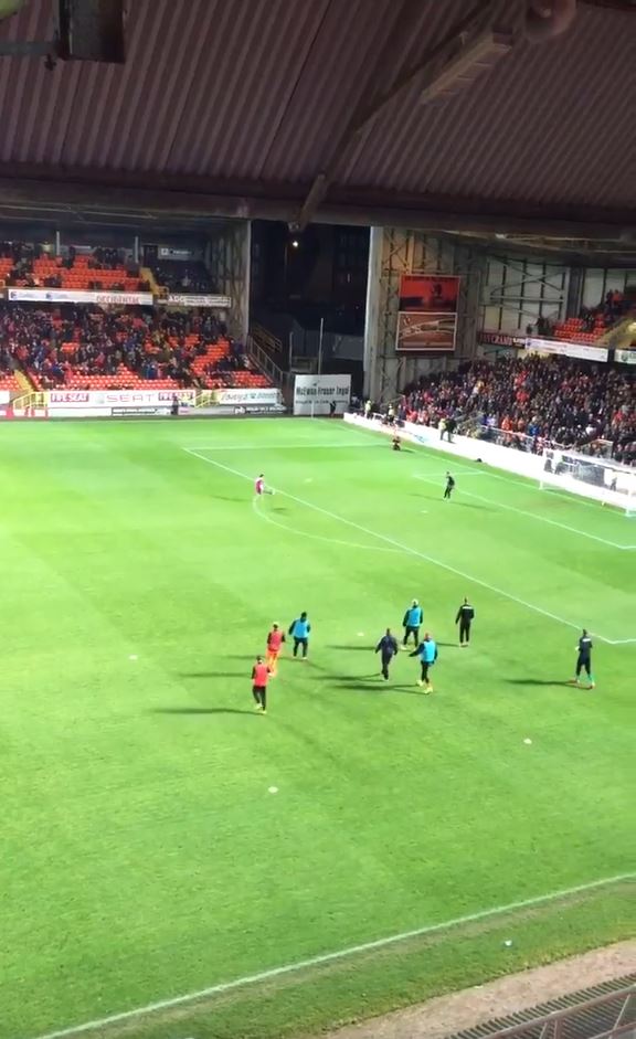  The Dundee United and Dunfermline substitutes run onto the pitch to show their support