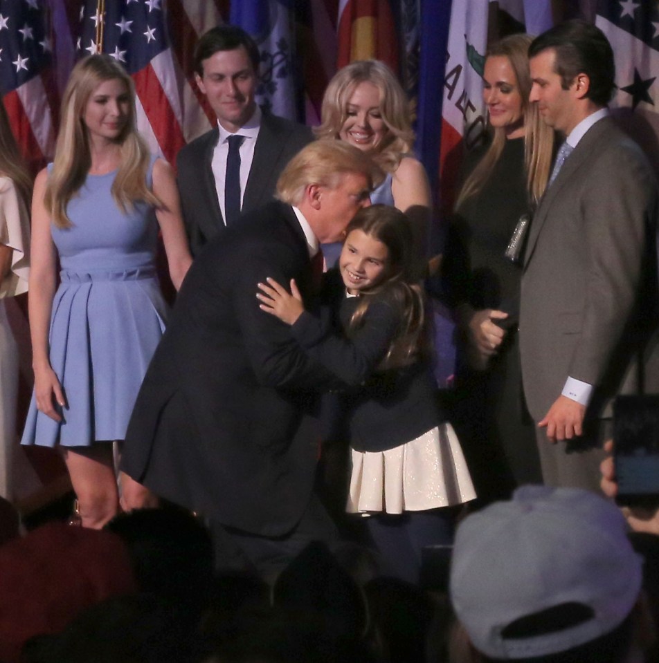  Donald Trump pictured with his family and bending down to kiss his first granddaughter, Kai Madison Trump