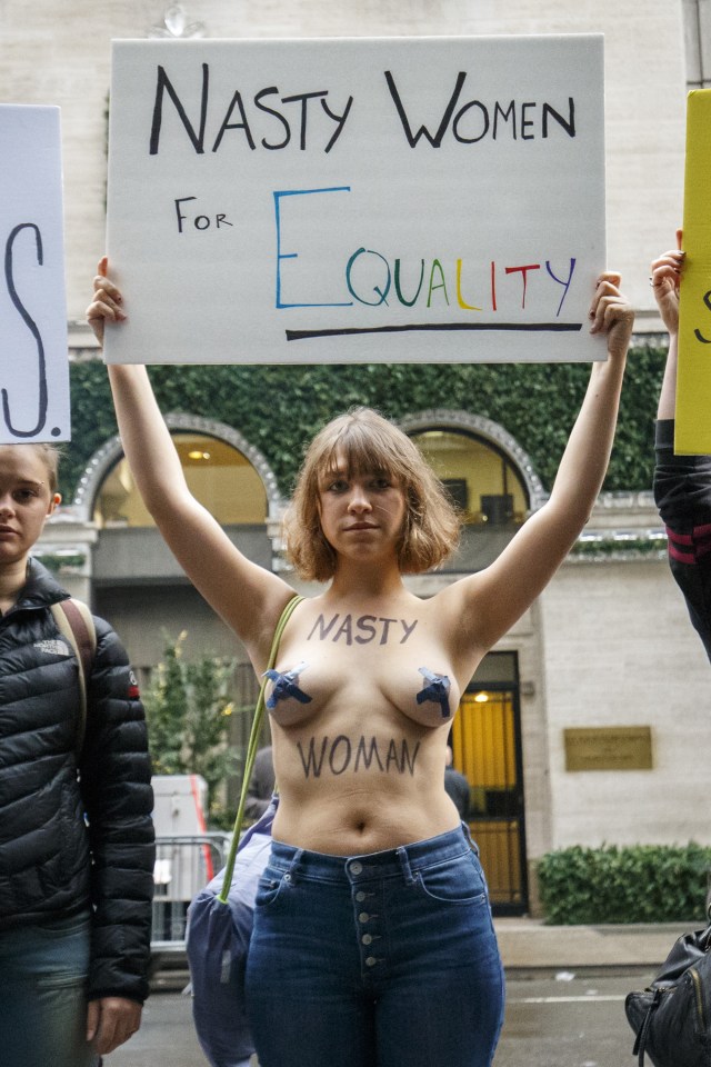  A topless anti-Trump campaigner protests outside Trump Tower in New York City