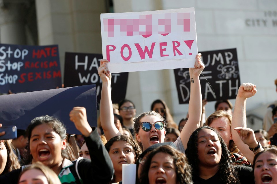  The 'P' word... A woman holds a sign condemning Trump's alleged sexism