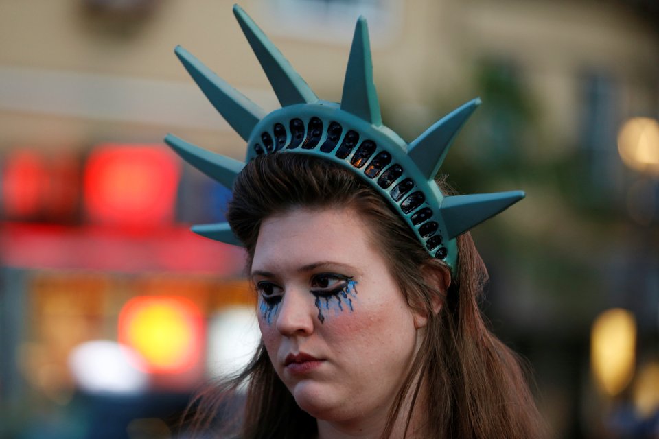  Cry freedom... A demonstrator wears a headpiece depicting the crown of the Statue of Liberty