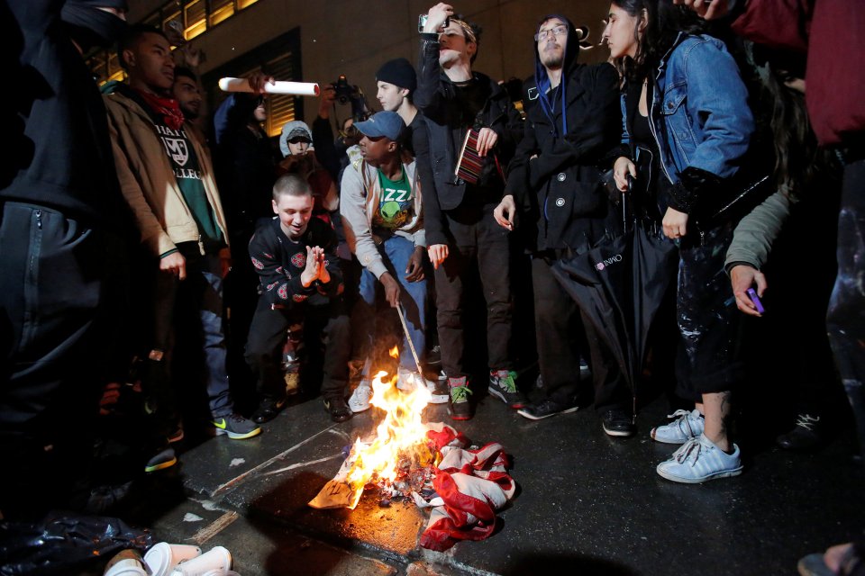  Protesters burn a US flag outside Trump Tower following Donald Trump's election victory in Manhattan