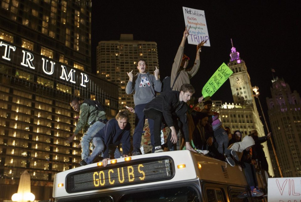  Demonstrators protest on top of a bus outside of the Trump Tower in Chicago