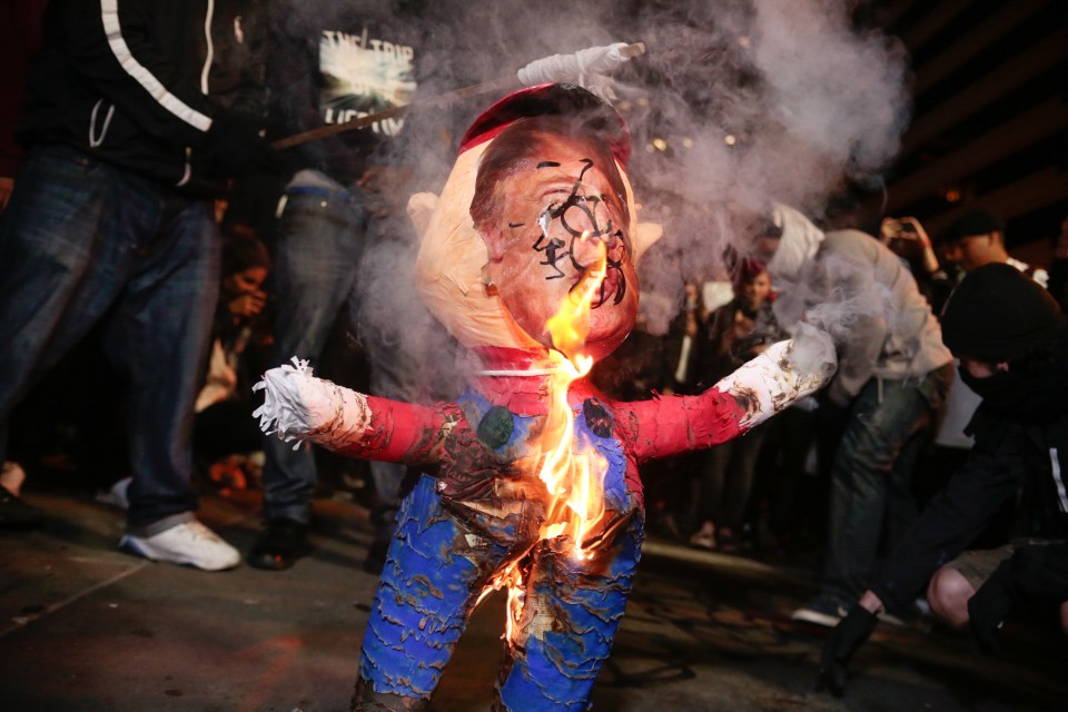  An effigy of Trump is burned in downtown Oakland, California