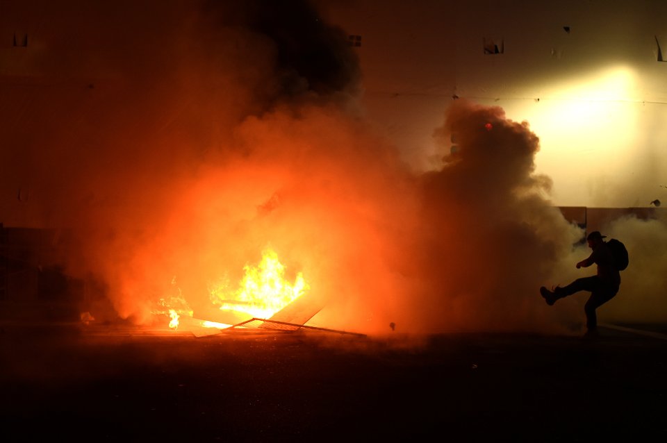  OAKLAND... A protester kicks an object as demonstrators riot in Oakland, California