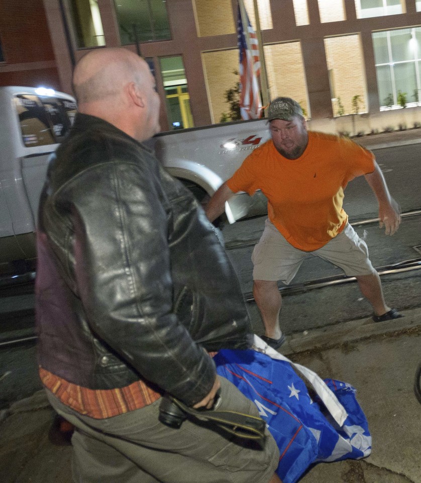  The Trump supporter, right, looked set to lunge at his opponent as tensions boiled over after election night