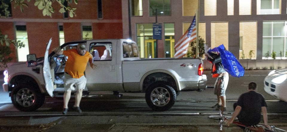  A Republican supporter in New Orleans jumped out of his truck to attack a man who stole his pro-Trump flag