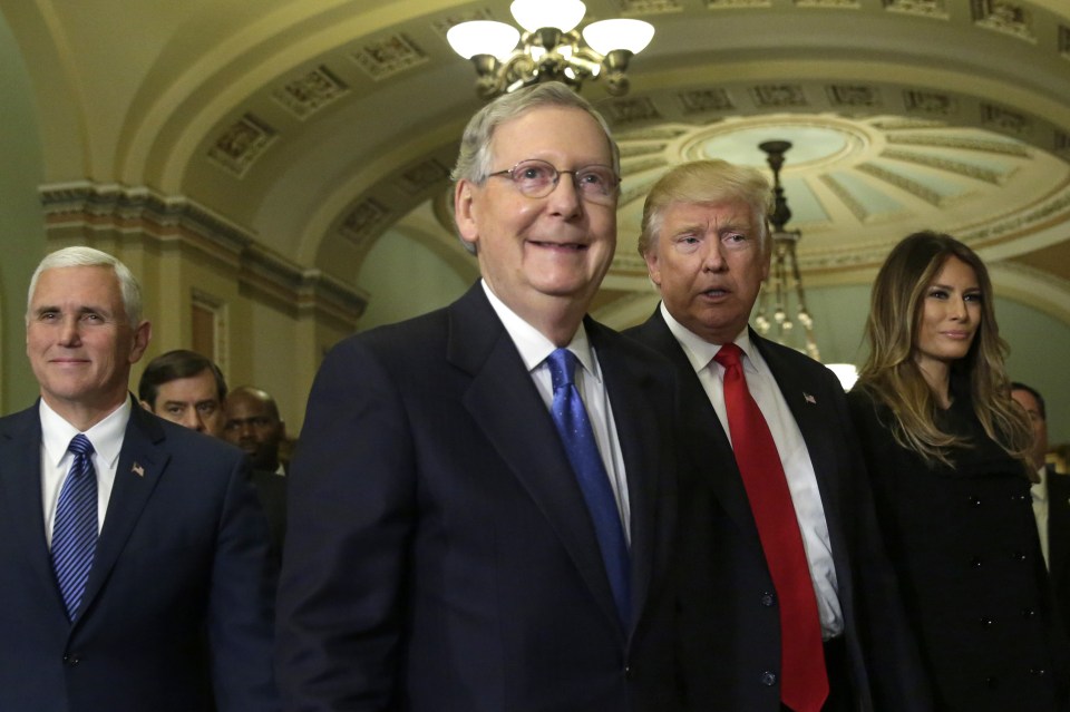  Mitch McConnell (centre) smiles as he walks with President-elect Donald Trump with his wife Melania and Vice President-elect Mike Pence