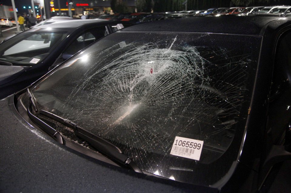  A smashed car window following another night of protests to the election of Donald Trump