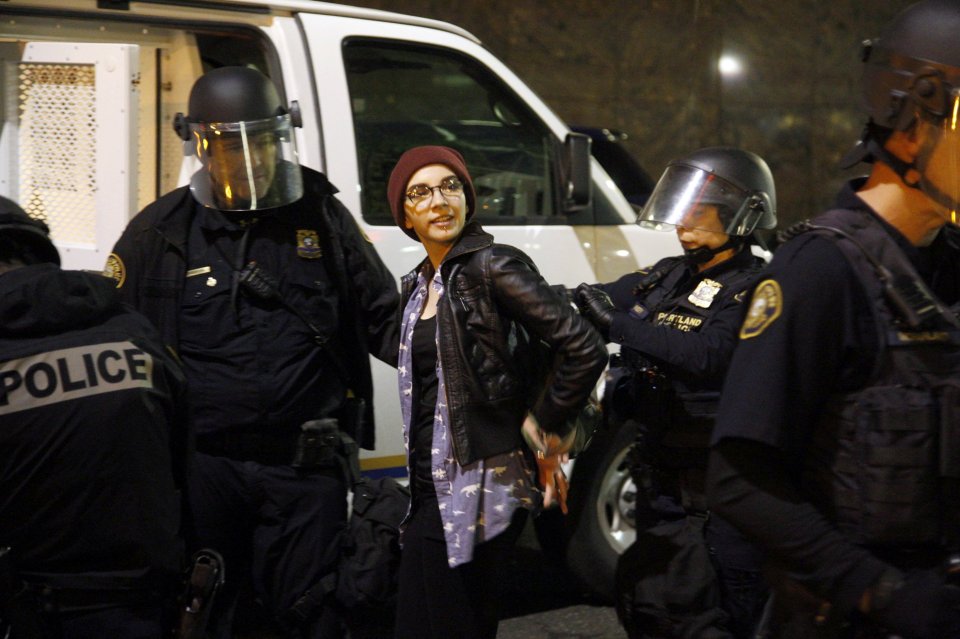  Cops detain a demonstrator during a protest against the election of Republican Donald Trump