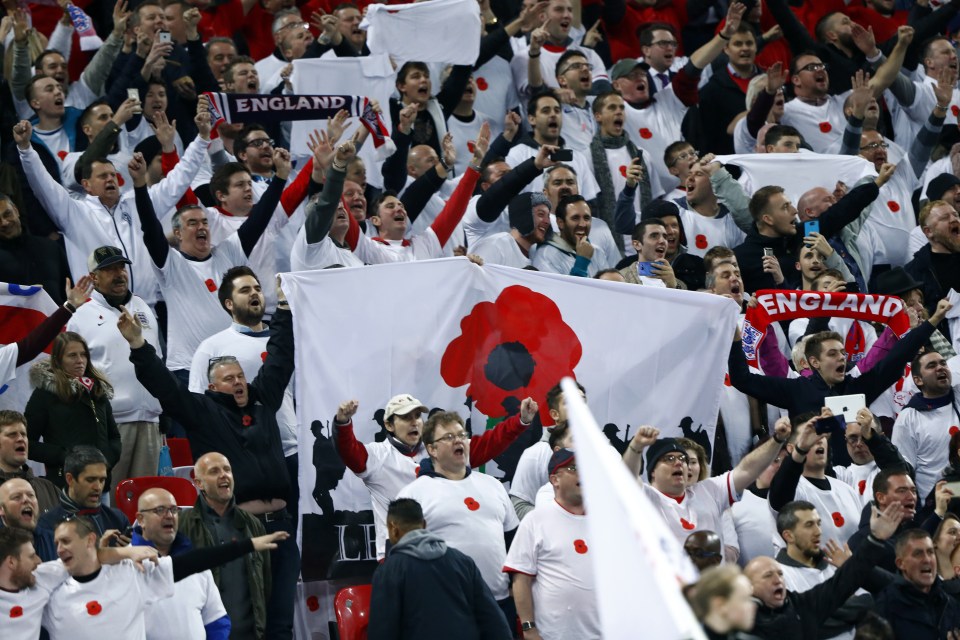 Fans in the crowd pay their respects to fallen war heroes