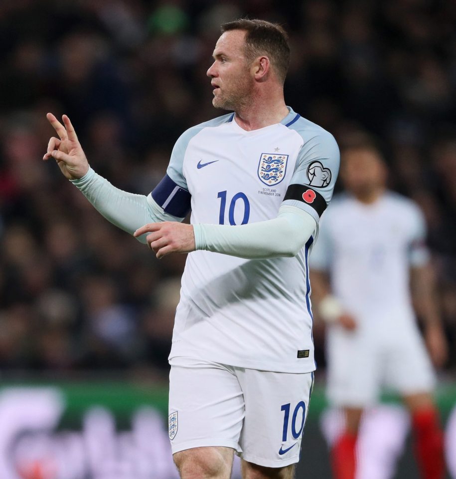  Wayne Rooney shows the poppy England footballers wore last night